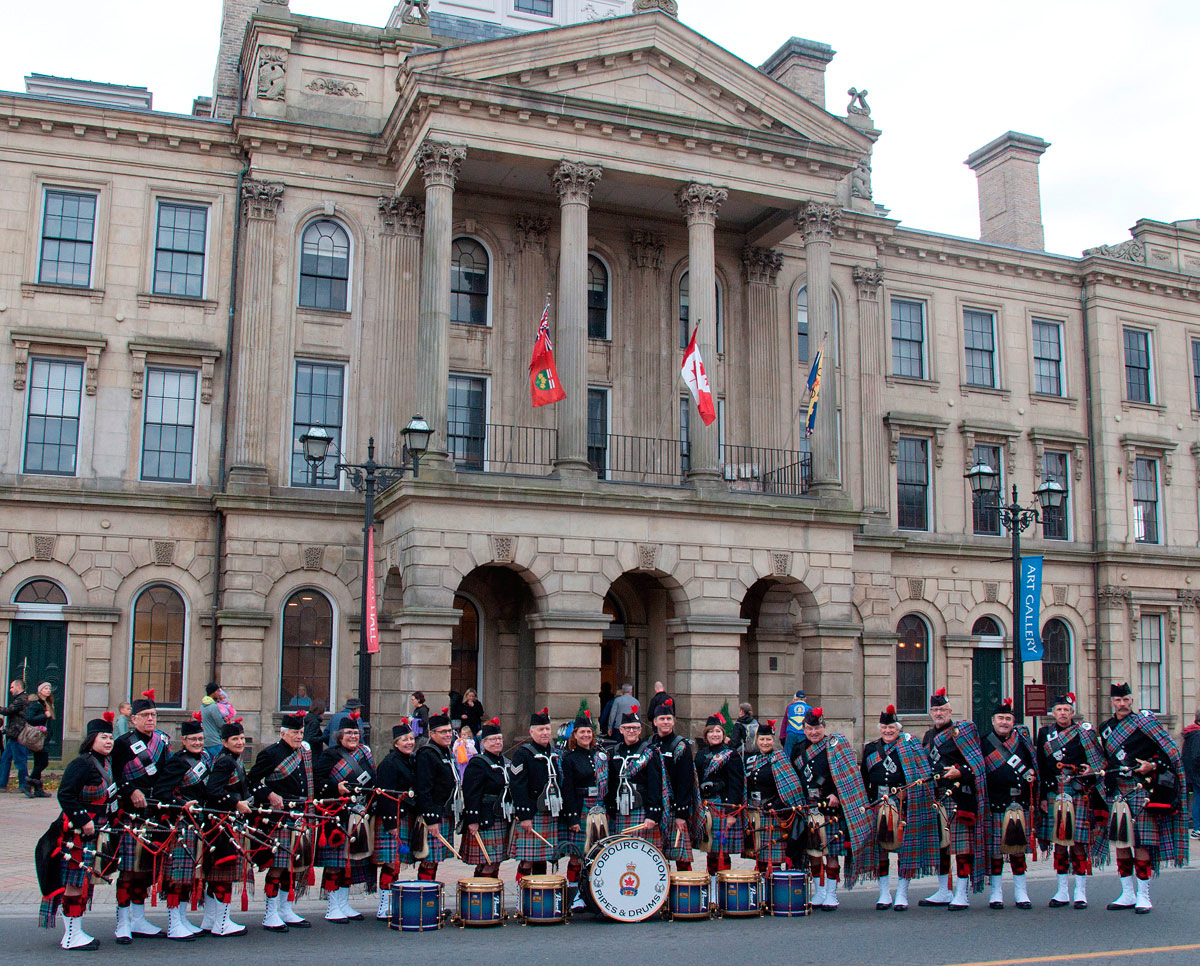 The Cobourg Legion Pipes and Drums assembled outside Victoria Hall