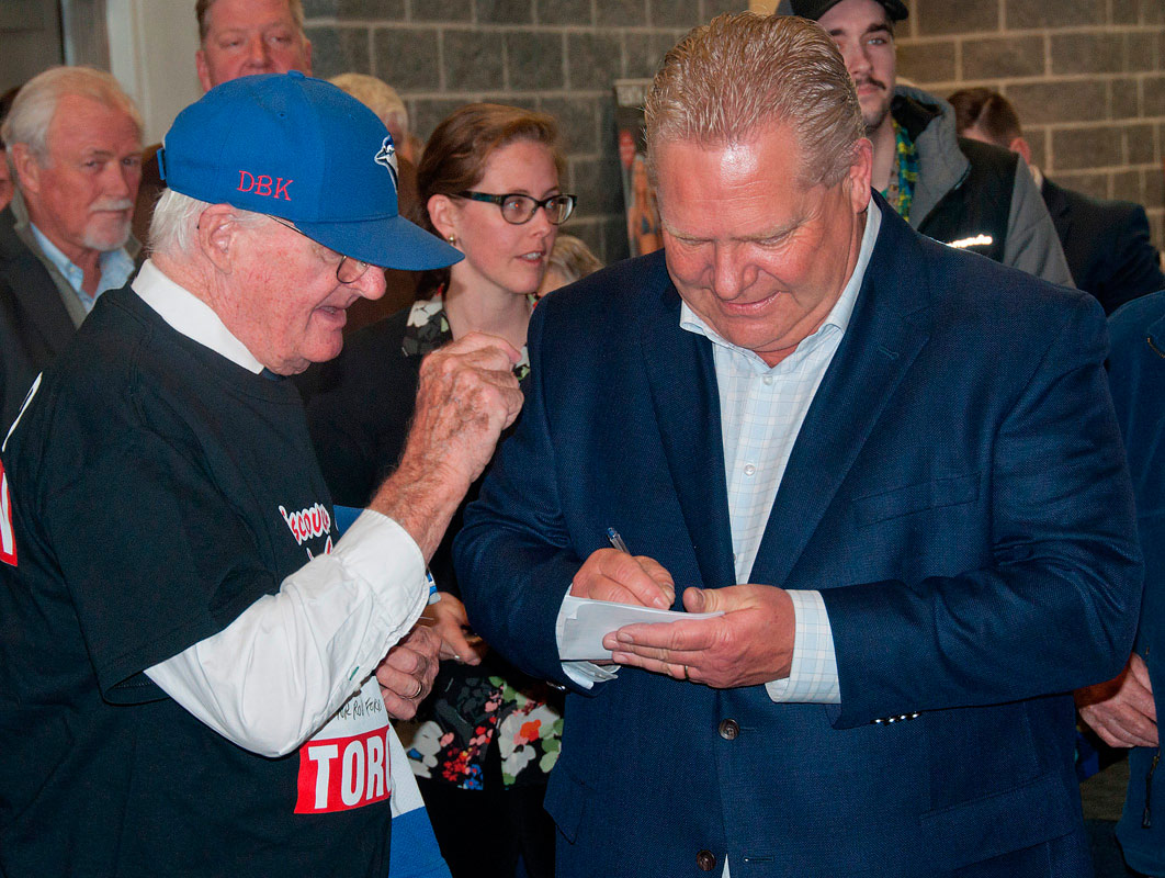 Doug Ford giving an autograph to a fan